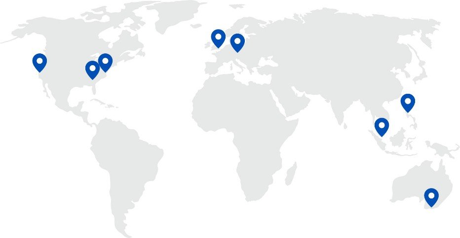 World map with light grey continents with blue pins showing office locations on map