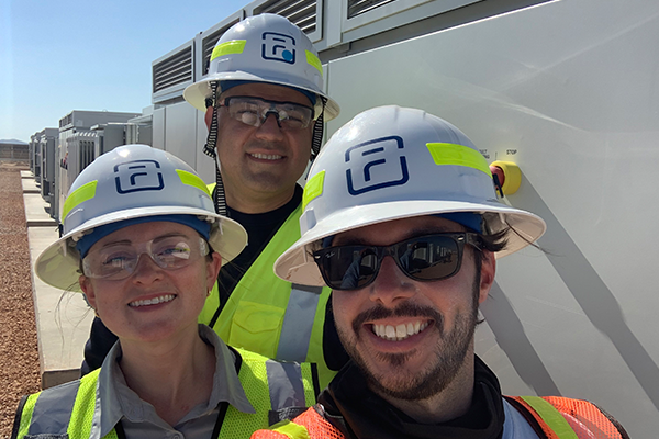 People smiling in hard hats and safety vests